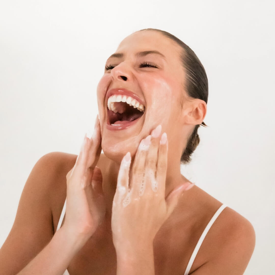 woman applying cleanser