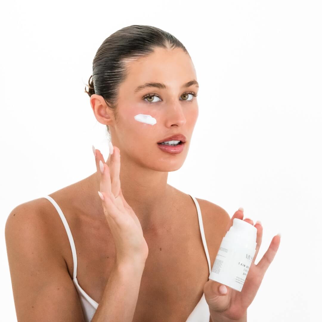 woman applying skin brighter cream